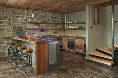 Mid-sized farmhouse u-shaped concrete floor open concept kitchen photo in Other with a single-bowl sink, flat-panel cabinets, medium tone wood cabinets, concrete countertops, gray backsplash and paneled appliances