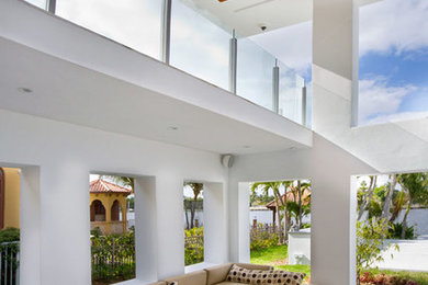 Photo of a mid-sized modern enclosed living room in Miami with white walls, no fireplace, no tv and grey floor.