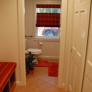 Cushioned bench seating with shoe cubbies below opposite generous coat closet.