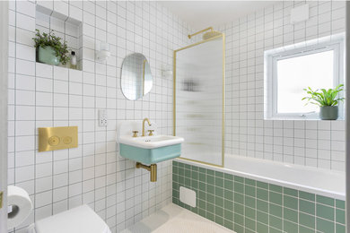 This is an example of a medium sized contemporary family bathroom in London with green tiles, a single sink and a floating vanity unit.