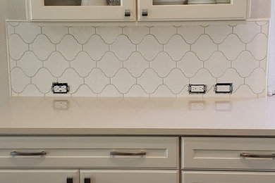 Inspiration for a small timeless eat-in kitchen remodel in San Diego with quartzite countertops, white backsplash, porcelain backsplash, stainless steel appliances, an island and beige countertops