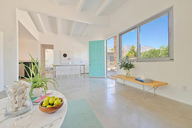1960s concrete floor and gray floor entryway photo in Other with white walls and a green front door