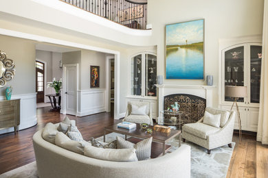 Large elegant open concept dark wood floor and brown floor living room photo in Charleston with beige walls, a standard fireplace, a wood fireplace surround and no tv