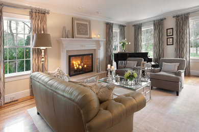 Living room - large eclectic formal and open concept light wood floor and brown floor living room idea in New York with beige walls, a standard fireplace, a plaster fireplace and no tv