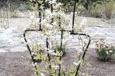 Design ideas for a mid-sized traditional full sun backyard stone formal garden in Boston for summer.