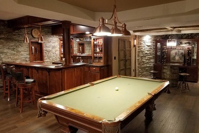Basement - traditional underground dark wood floor and brown floor basement idea in Columbus with gray walls