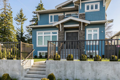 Design ideas for a three-storey blue house exterior in Vancouver with concrete fiberboard siding and a gable roof.