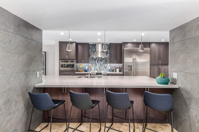 Inspiration for a modern kitchen remodel in Phoenix with dark wood cabinets, multicolored backsplash, stainless steel appliances and gray countertops