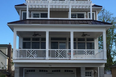 Example of a mid-sized beach style beige three-story mixed siding exterior home design in New York with a metal roof