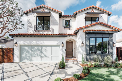 Mediterranean white two-story exterior home idea in Los Angeles with a tile roof