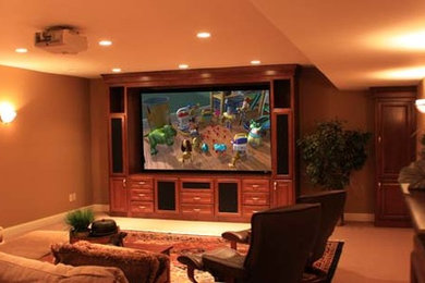 Inspiration for a mid-sized traditional enclosed home theatre in Other with beige walls, carpet and a projector screen.