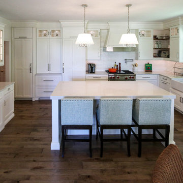 White Kitchen with Gray Quartz Countertops, Farmhouse Sink and Hardwood Floors