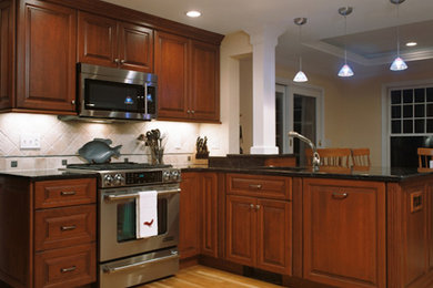 Kitchen pantry - large traditional l-shaped light wood floor kitchen pantry idea in Boston with a drop-in sink, raised-panel cabinets, dark wood cabinets, white backsplash, stainless steel appliances and no island