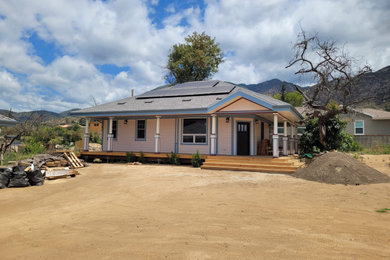 Large traditional pink one-story exterior home idea in Los Angeles with a shed roof, a shingle roof and a gray roof
