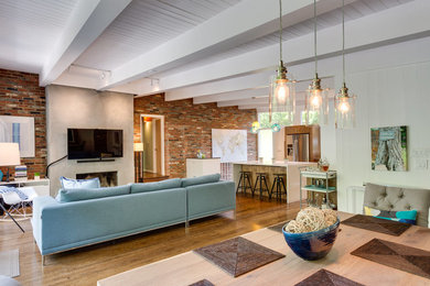 Example of a large 1950s open concept medium tone wood floor and brown floor living room design in Los Angeles with a bar, red walls, a standard fireplace, a concrete fireplace and a wall-mounted tv