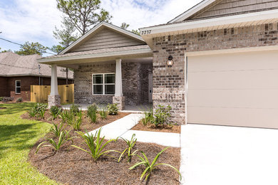 Mid-sized trendy brown one-story brick exterior home photo in Miami with a shingle roof