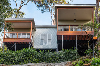 This is an example of a beach style home design in Sunshine Coast.