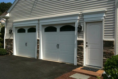 Mid-sized minimalist attached two-car garage photo in Philadelphia