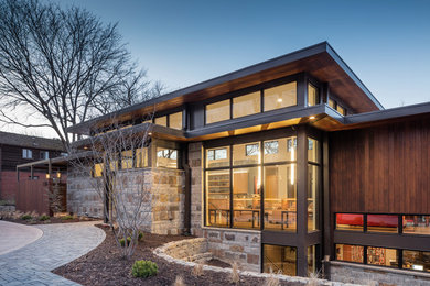 Large contemporary brown two-story wood flat roof idea in Kansas City