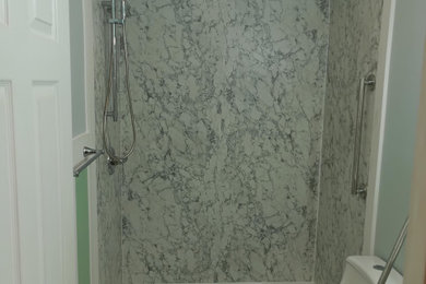 Bathroom - mid-sized modern 3/4 vinyl floor, multicolored floor and single-sink bathroom idea in Charlotte with recessed-panel cabinets, white cabinets, a one-piece toilet, white walls, an undermount sink, quartz countertops, white countertops and a freestanding vanity