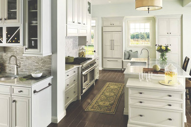 Design ideas for a large transitional l-shaped kitchen in Boston with a double-bowl sink, recessed-panel cabinets, white cabinets, marble benchtops, grey splashback, panelled appliances, dark hardwood floors and with island.