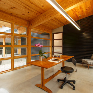 Inspiration for a modern home office and library in Baltimore with concrete flooring and a freestanding desk.