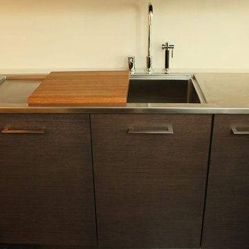 Dark Stained Rift Cut Oak Cabinets and Stainless Steel Sink