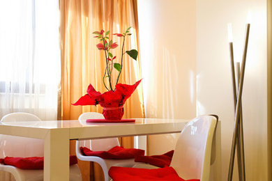Small minimalist dark wood floor enclosed dining room photo in Other with white walls