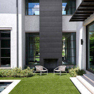 Large contemporary front yard full sun garden in Dallas with with fireplace.