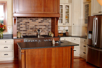 Inspiration for a mid-sized timeless u-shaped medium tone wood floor eat-in kitchen remodel in New York with an undermount sink, beaded inset cabinets, white cabinets, quartz countertops, multicolored backsplash, ceramic backsplash, stainless steel appliances and an island