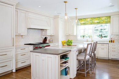 Eat-in kitchen - large transitional l-shaped medium tone wood floor eat-in kitchen idea in DC Metro with a farmhouse sink, recessed-panel cabinets, beige cabinets, quartzite countertops, white backsplash, subway tile backsplash, colored appliances and an island