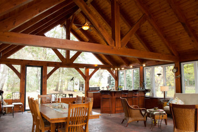 Mid-sized mountain style open concept multicolored floor, wood ceiling and wood wall living room photo in Other with brown walls