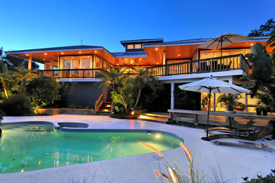 Large island style gray two-story vinyl exterior home photo in Tampa