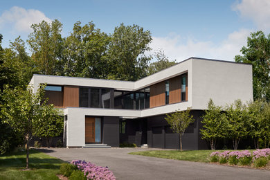 Example of a minimalist white two-story exterior home design in New York
