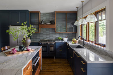 ルイビルにある高級な中くらいなトランジショナルスタイルのおしゃれなキッチン (エプロンフロントシンク、シェーカースタイル扉のキャビネット、青いキャビネット、珪岩カウンター、青いキッチンパネル、セラミックタイルのキッチンパネル、黒い調理設備、濃色無垢フローリング、茶色い床、グレーのキッチンカウンター) の写真