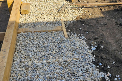 Photo of a mid-sized contemporary full sun backyard wood fence retaining wall landscape in Calgary with decking for summer.