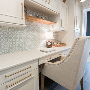 Small country study room in Other with white walls, vinyl floors, a built-in desk and brown floor.
