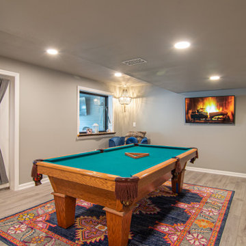 Basement Utilizing Open Space to Shoot Pool and Watch Favorite Sports Team
