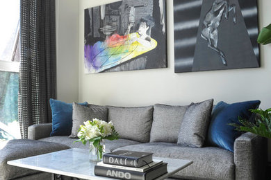 Trendy enclosed light wood floor living room photo in Vancouver with beige walls