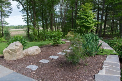 Photo of a mid-sized traditional partial sun backyard mulch landscaping in Boston.