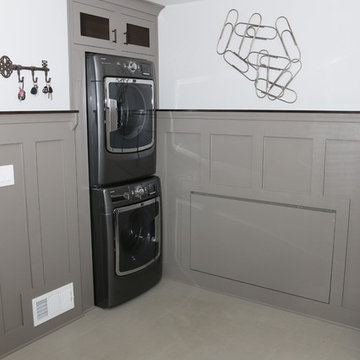 Multifunctional Room Design Featuring Gray Wainscoting and Stackable Laundry