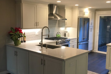 Photo of a small traditional l-shaped eat-in kitchen in San Diego with a single-bowl sink, shaker cabinets, white cabinets, quartz benchtops, grey splashback, ceramic splashback, stainless steel appliances, dark hardwood floors and no island.