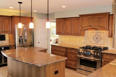 Eat-in kitchen - large modern l-shaped ceramic tile eat-in kitchen idea in Detroit with a double-bowl sink, medium tone wood cabinets, granite countertops, beige backsplash, mosaic tile backsplash, stainless steel appliances and an island