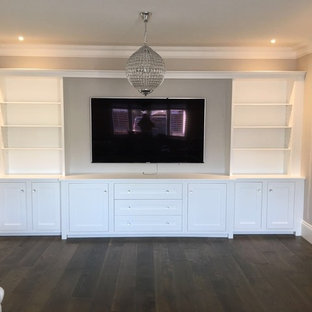 This is an example of a large eclectic open plan home cinema in New York with plywood flooring and a built-in media unit.