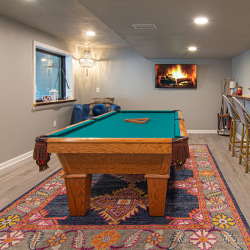 Basement Utilizing Open Space to Shoot Pool and Watch Favorite Sports Team