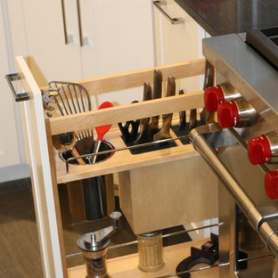 Large transitional kitchen pantry remodeling - Example of a large transitional l-shaped porcelain floor kitchen pantry design in Detroit with an undermount sink, shaker cabinets, white cabinets, quartzite countertops, gray backsplash, stone tile backsplash, stainless steel appliances and two islands