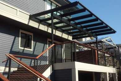 Contemporary green three-story flat roof idea in Seattle