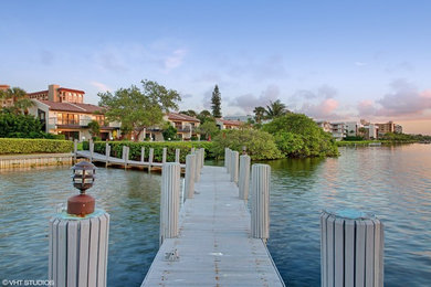 Design ideas for a coastal full sun backyard landscaping in Miami with decking for summer.