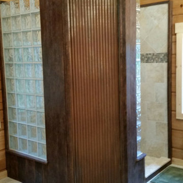 Reclaimed corrugated metal and barnwood with a contemporary glass block shower