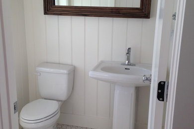 Powder room - small farmhouse powder room idea in Salt Lake City with a pedestal sink and white walls